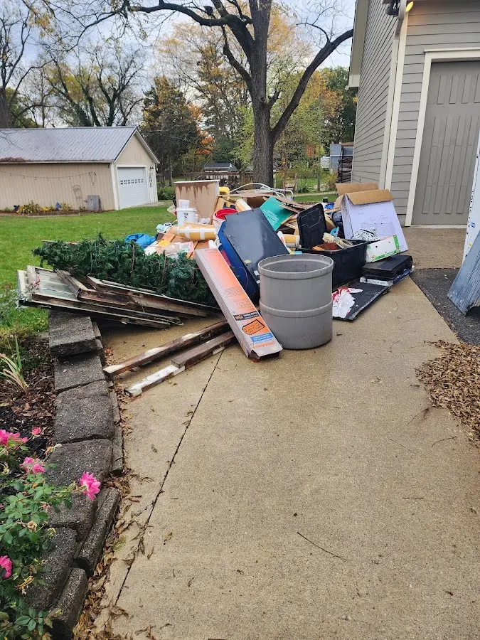 Dumpster being loaded with debris for 12 Yard Dumpster Rental in East Hanover